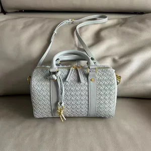 Detailed view of light blue woven leather Boston handbag, vintage style shoulder crossbody bag.