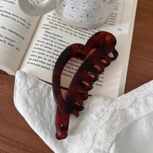 Vista detallada de primer plano de una elegante pinza para el cabello de carey con corazón.
