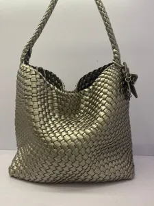 Close-up of the metallic woven texture and stylish hobo design of this chic shoulder bag.