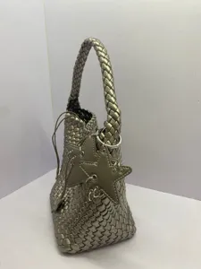 Metallic woven leather bucket bag with braided handle and stylish star charms for women.