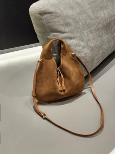 Stylish brown suede triangle bag for women, retro dumpling crossbody and shoulder purse.