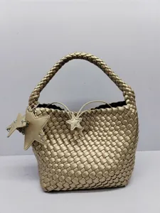 Gold woven shoulder bag featuring a stylish bucket design and cute star charms for casual wear.