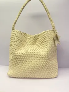 Woven leather shoulder bag detail, stylish hobo tote design featuring cute star charm pendant.