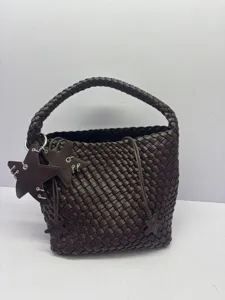 Detailed view of dark brown woven leather bucket bag with stylish star charms and handle.