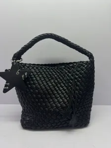 Detailed view of the stylish black woven leather bucket bag featuring unique star charms.