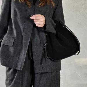 Black suede dumpling bag cross-body shoulder handbag detailed view showcasing premium texture.