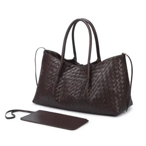 Detailed shot of dark brown woven leather tote bag, showing classic intrecciato texture.