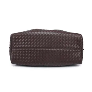 Detailed view of dark brown woven leather tote bag base, vintage fashion handbag design.