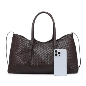 Detailed view of the dark brown leather woven tote bag, showcasing premium intrecciato texture.