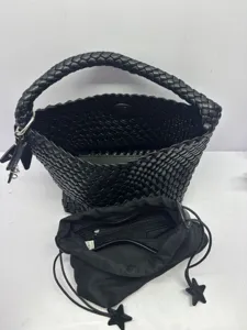 Black woven bucket bag with braided handle and star inner pouch, stylish casual tote.