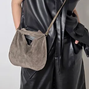 Suede triangular dumpling crossbody bag for women, stylish autumn leather shoulder handbag.