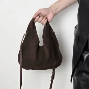 Dark brown suede triangular dumpling bag, minimalist leather crossbody shoulder handbag for women.