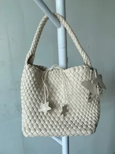 Beige woven bucket bag for women, stylish leather-look shoulder tote with cute star charms.