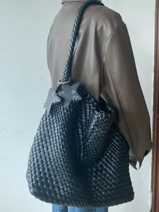 Black woven leather tote bag large capacity casual shoulder bucket bag with star charms.