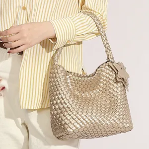 Metallic gold woven shoulder bag for women, large capacity hobo tote with star charm.