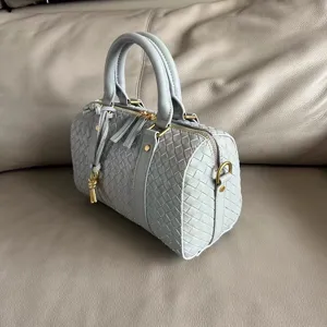 Detail view of the retro leather woven boston handbag, showing premium craftsmanship and texture.