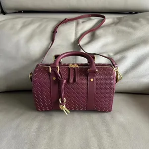Genuine leather woven Boston shoulder bag for women, retro style large capacity handbag detail.