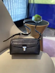 Black leather messenger bag detail, premium vegetable-tanned cowhide crossbody bag style.