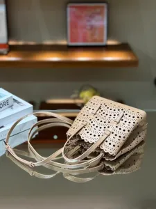 Detailed view of the nude leather laser cut tote bag showing intricate perforated patterns.