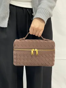 Brown woven cosmetic bag, stylish top handle vanity case with double gold zippers for women.