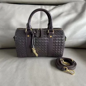 Dark brown woven leather boston bag detail showing intricate intrecciato craftsmanship.