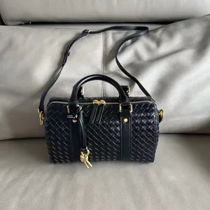 Black woven leather Boston bag detail, premium leather texture, elegant daily crossbody.
