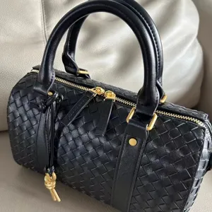 Black woven leather Boston handbag detail showing exquisite craftsmanship and premium texture.