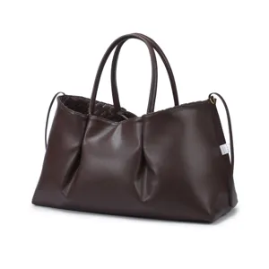 Brown leather tote bag for women, vintage slouchy shoulder bag with woven interior detail.