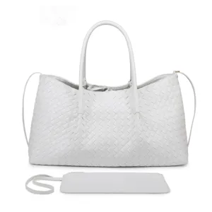 Detailed view of the white woven leather tote bag showcasing intricate texture and matching pouch.
