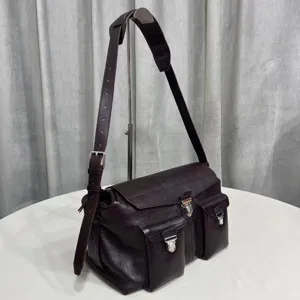 Detailed view of the retro dark leather messenger bag featuring multiple front pockets and hardware.