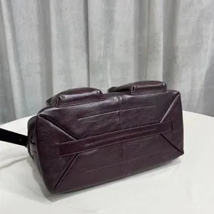 Premium leather messenger bag with vintage motorcycle style and unique structural design.