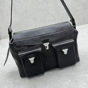 Black leather messenger bag with front pockets and silver hardware for daily stylish commute.