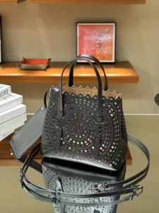 Black leather laser cut tote bag French style chic shoulder handbag for women daily casual use.
