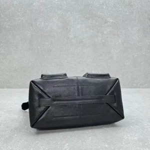 Detailed bottom view of black leather messenger bag, vintage motorcycle style, premium cowhide.