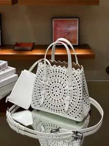 White leather laser-cut tote bag, chic casual shoulder handbag with pouch and strap for women.