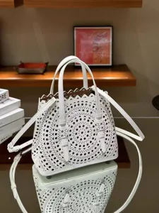 White leather hollow-out handbag, chic French casual design, elegant shoulder crossbody bag.