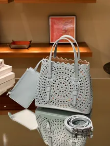 Light blue leather laser cut tote bag with detachable pouch, shoulder strap and chic scalloped.