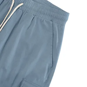Close-up of men's casual cargo shorts waistband, drawstring detail, and fabric texture.