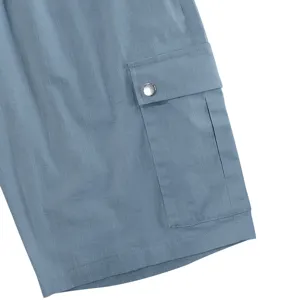 Close-up detail of casual cargo shorts pocket with snap button and textured fabric.
