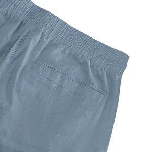 Men's casual shorts detail showing elastic drawstring waistband and back pocket in grey blue.