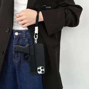 Creative pistol shape phone case detail shot, cool black design with lanyard, unique style.