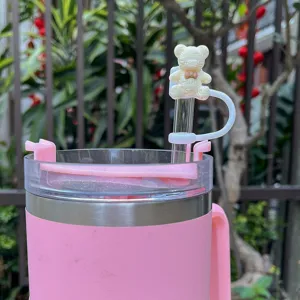 Pink insulated tumbler with cute bow tie bear silicone straw cap cover detail view