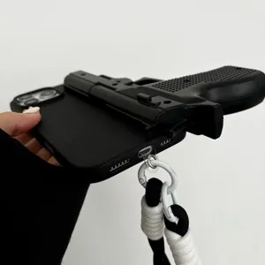 Detailed close-up shot of the creative black toy gun phone case with matching woven lanyard.