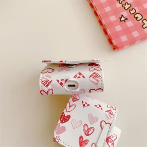 White leather AirPods case featuring red sketch heart patterns, cute wireless earphone protector.