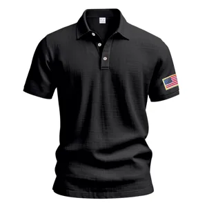 Close-up detail of black men's short sleeve polo shirt with American flag sleeve embroidery.