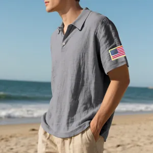 Detailed view of breathable grey linen polo shirt short sleeve with American flag patch.