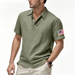 Close-up detail of mens green linen polo shirt featuring American flag patch on left sleeve.