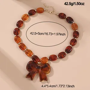 Braune Perlenkette mit Schleife Anhänger, Harz Choker Halskette für Damen Schmuck.