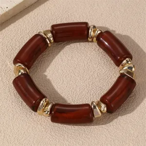 Vintage braune Harz Zylinder Perlenarmband mit unregelmässigen goldenen Metallabstandhaltern.