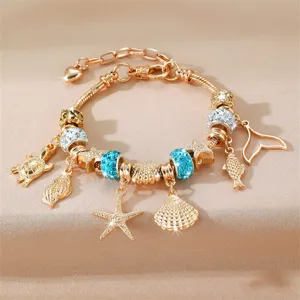 Χρυσό βραχιόλι με charms σε στιλ ωκεανού DIY με αστερίες κοχύλια και μπλε στραζ παραλία.